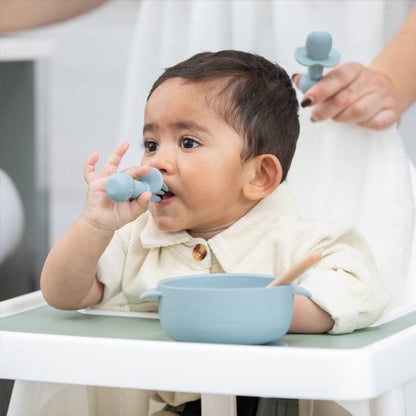 Bébé mange avec couvert bébé bleu